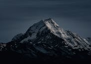 Best Outdoor Adventures in Seattle Majestic snow-covered peak in New Zealand captured at night, showcasing its striking silhouette.
