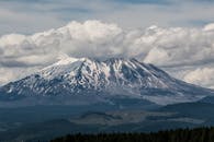 Best Outdoor Adventures in Seattle A breathtaking view of Mount St. Helens with snow-capped peaks and dramatic clouds.